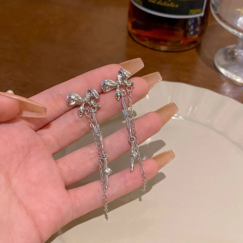 ChatGPT said:  Silver Bow Dagger Drop Earrings (Code-ZX#700)